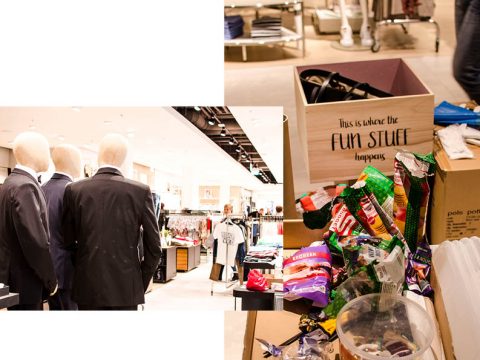 Links zeigt ein Geschäft Schaufensterpuppen in Anzügen. Rechts sind verschiedene bunte Süßigkeiten und Snacks neben einer Holzkiste mit der Aufschrift „Hier passiert der Spaß“ verstreut.