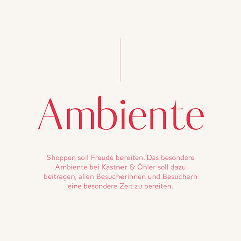 Der Text in deutscher Sprache auf hellem Hintergrund lautet in roter Schrift: „Ambiente. Shoppen soll Freude bereiten. Das besondere Ambiente bei Kastner & Öhler soll dazu beitragen, allen Besucherinnen und Besuchern eine besondere Zeit zu bereiten.“