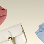 Eine beige Handtasche, ein rosa gefaltetes Hemd und ein blaues gefaltetes Poloshirt sind vor einem hellbeigen Hintergrund angeordnet. Die Artikel sind diagonal angeordnet und teilweise von den Ecken aus sichtbar.
