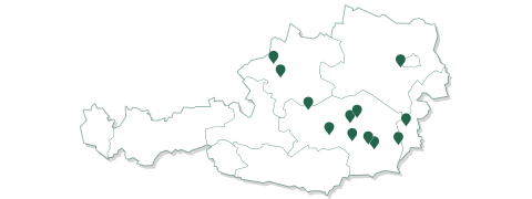 Eine Umrisskarte von Österreich mit mehreren grünen Standortmarkierungen, die über verschiedene Regionen verteilt sind. Die Karte ist leer und ohne Beschriftungen oder zusätzliche Details.