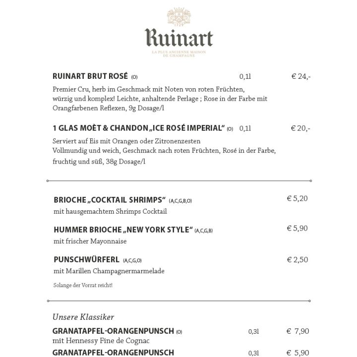 Ein festliches Menü mit dem Titel „Champagnerbar“ mit Dom Pérignon- und Ruinart-Champagnern im Glas oder in der Flasche, klassischen Hotdogs nach New Yorker Art und Weihnachtsgetränken wie Orangenpunsch und Chai Latte. Die Preise sind neben jedem Gericht aufgeführt.