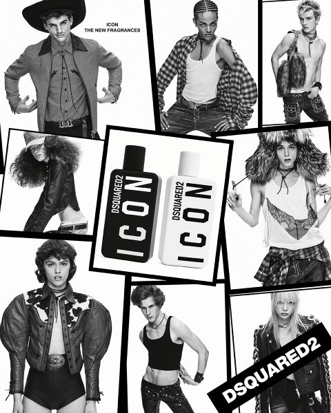 Ein Mann in schwarzem Zweireiher und grauer Krawatte steht selbstbewusst vor abstrakter Kunst. Neben ihm steht auf einer Holzfläche eine schwarze Lampe mit Messingakzenten. Das Ambiente wirkt modern und stilvoll.