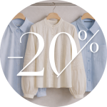 Drei Hemden mit Kragen hängen auf Kleiderbügeln, zwei blaue und ein weißes, mit der Aufschrift "-20%", die auf einen Rabatt von 20% auf Kleidung hinweist.