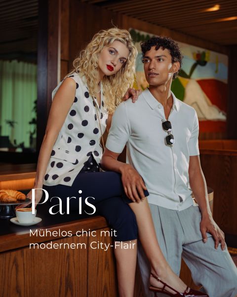 Eine stilvolle Frau und ein Mann posieren in einem modernen Café; der Text lautet: "Paris: Mühelos chic mit modernem City-Flair". Neben ihnen liegen Croissants auf dem Tresen.