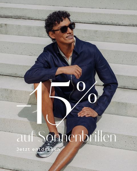Ein Mann mit Sonnenbrille und in marineblauer Kleidung sitzt auf einer Freitreppe. Der Text lautet: „-15 % auf Sonnenbrillen. Jetzt entdecken.“.