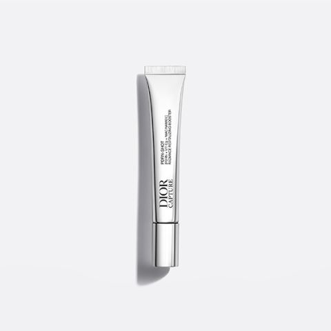 Eine silberne Tube mit der Aufschrift „Dior Capture“, die aufrecht auf einem weißen Hintergrund steht und deren Schatten nach rechts fällt.