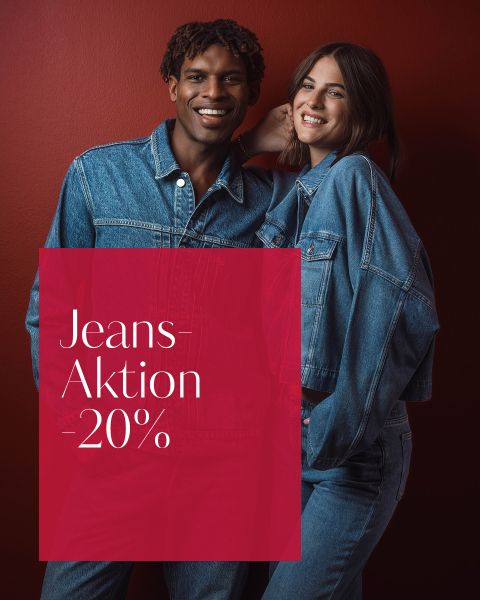 Zwei Personen in Jeans-Outfits lächeln vor einem roten Hintergrund. Auf einem roten Kasten steht in weißer Schrift „Jeans-Aktion –20 %“.